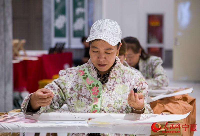 非遺傳承人現場展示“海原千針繡”技藝。 人民網 張海峰攝