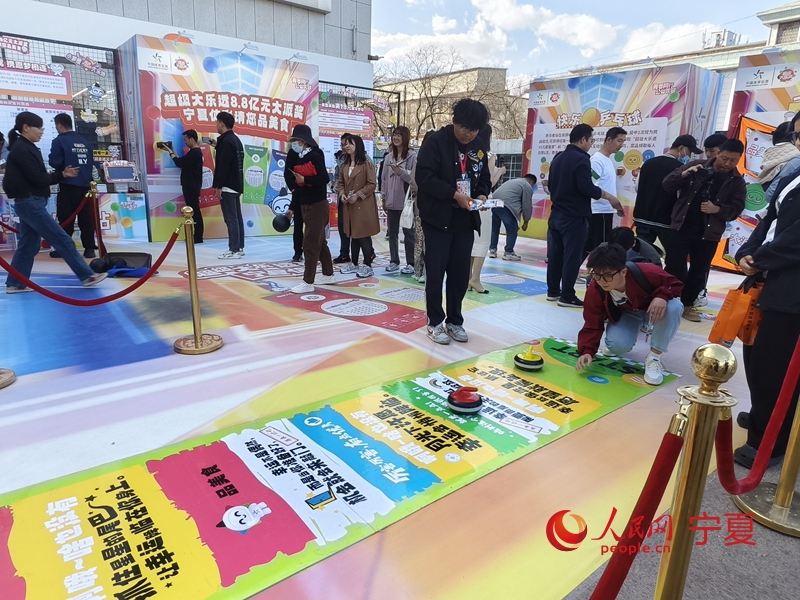 活動現場市民體驗趣味冰壺。人民網記者 梁宏鑫攝